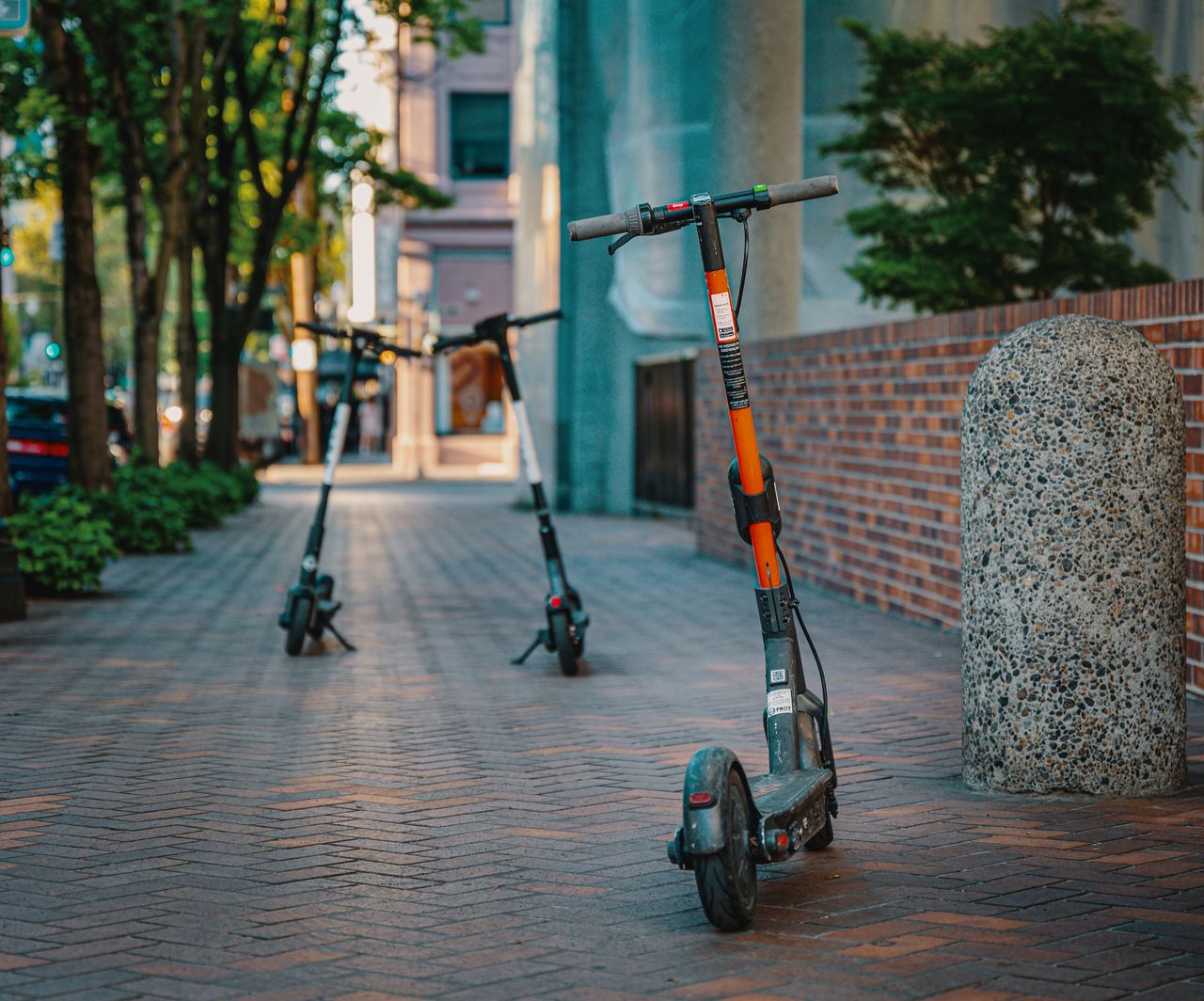 About Electric scooters parked on a city sidewalk, embracing urban transportation and modern mobility.